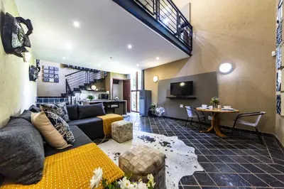 a living room with a couch and a table at Craigivar Guesthouse in Pretoria