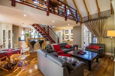 a living room with a couch and a table at Craigivar Guesthouse in Pretoria