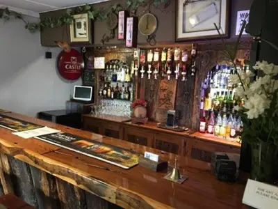a bar with a lot of bottles of alcohol at Guinea Feather Country Lodge & Spa in Groblersdal