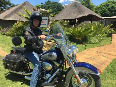 a man is sitting on a motorcycle at Guinea Feather Country Lodge & Spa in Groblersdal