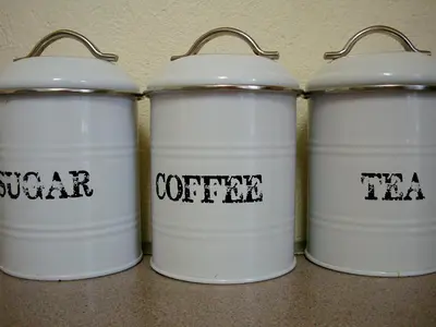 a group of four white drums with the words canteen at umSisi Cottage in White River