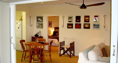 a living room with a table and a couch at umSisi Cottage in White River