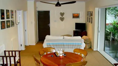 a living room with a table and a couch at umSisi Cottage in White River