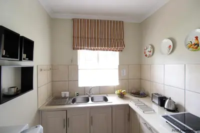 a kitchen with a sink and a window at Wilger Guesthouse in Centurion