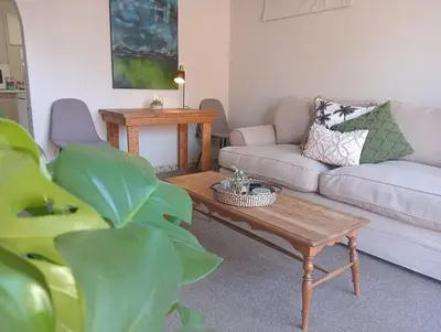 a living room with a couch and a coffee table at Willows Garden Cottage in Pretoria