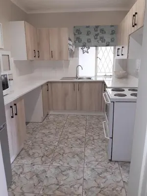 a kitchen with a sink and a stove top oven at Willows Garden Cottage in Pretoria