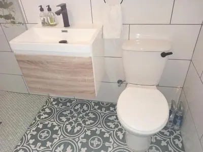 a bathroom with a white toilet and a sink at Willows Garden Cottage in Pretoria