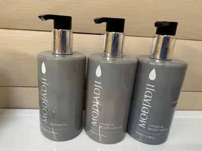 three grey bottles sitting next to each other on a shelf at Timmerstuga in Malelane