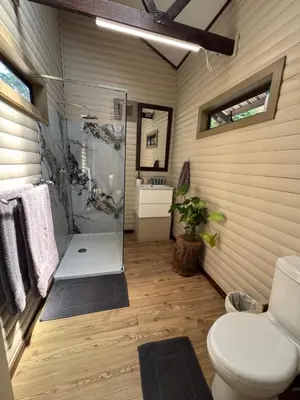 a bathroom with a shower and a toilet at Timmerstuga in Malelane