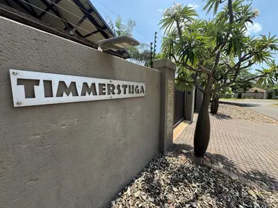 a sign on the side of a building at Timmerstuga in Malelane