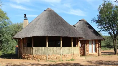 a small hut with a thatched roof at Thabaledi Game Lodge in Brits