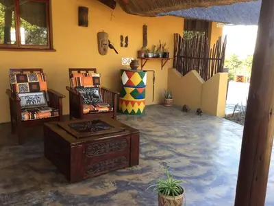 a living room with a couch and a table at Bushvilla Umoja Kruger in Phalaborwa