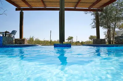 a large swimming pool with blue water at Kierieklapper in Hectorspruit