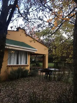 a house with a picnic table in front of it at Sanfern Downs Cottage in Haenertsburg