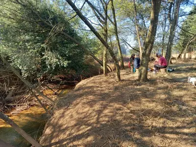 a group of people standing next to a river at Sanfern Downs Cottage in Haenertsburg