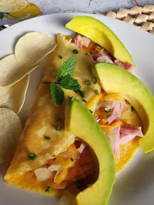 a white plate topped with two tacos with avocado at Kattekwaad Accommodation in Kaapsehoop