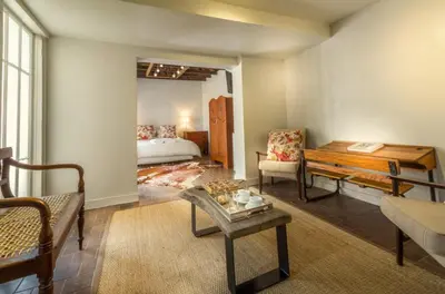 a living room with a bed and a table at Pierneef's Kraal in Pretoria