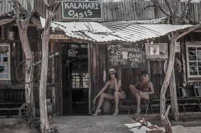 two naked men sitting in the doorway of a bar at Mingwe Private Game Lodge in Mabula