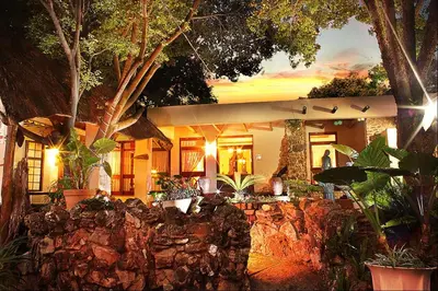 a house with a bunch of plants in front of it at Centurion Guest House and Lodge in Centurion