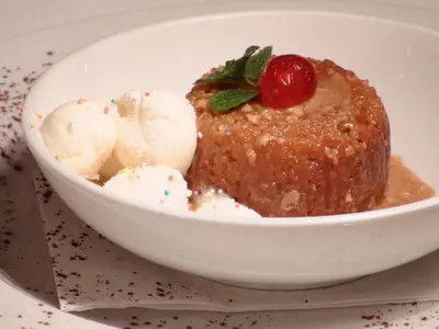a bowl of food with a piece of cake and ice cream at Polokwane Place in Polokwane