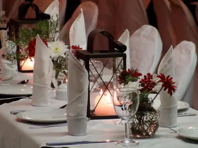a table with white table cloth with flowers and candles at Polokwane Place in Polokwane