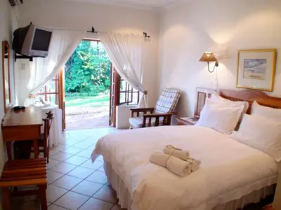 a bedroom with a bed with a teddy bear on it at Polokwane Place in Polokwane