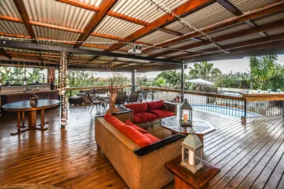 a living room with a couch on a deck at The Rest Guest House in Nelspruit