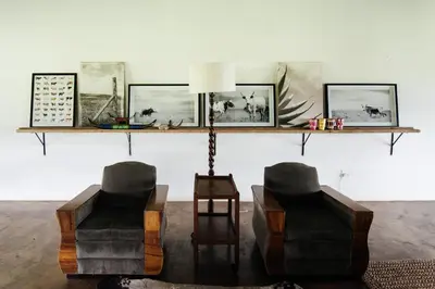 two chairs and a lamp in a living room at The Cowshed in Lydenburg
