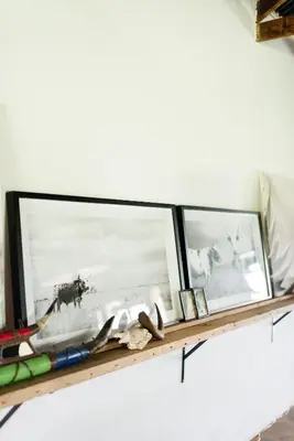 two mirrors on a shelf with a picture of a cow at The Cowshed in Lydenburg