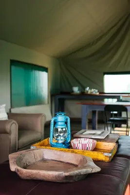a table with a blue lantern on top of it at The Cowshed in Lydenburg