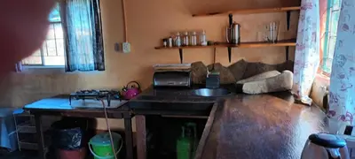 a kitchen with a counter and a sink in a room at Joy River Backpackers in Moremela