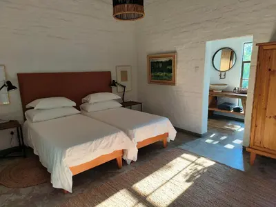 a bedroom with a large bed in a room at Eloff Guest House and Gallery in White River