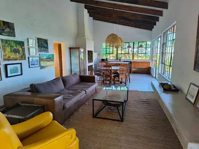 a living room with a couch and a table at Eloff Guest House and Gallery in White River