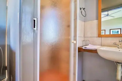 a bathroom with a sink and a mirror at Villa Paradiso in Hartbeespoort