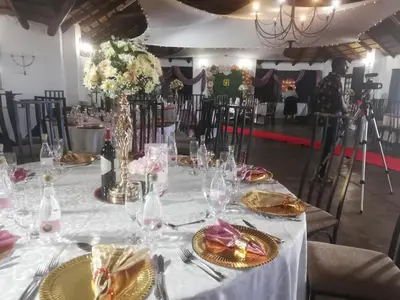 a table with a white table cloth and flowers on it at Villa Paradiso in Hartbeespoort