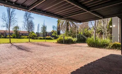 a brick patio with awning in a park at Wolf Unit in Pretoria