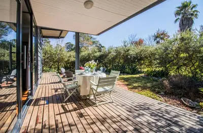 a patio with a table and chairs on a deck at Wolf Unit in Pretoria