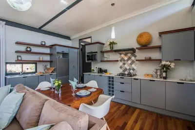a kitchen and living room with a table and a couch at Wolf Unit in Pretoria