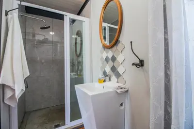 a bathroom with a sink and a shower at Wolf Unit in Pretoria