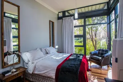 a bedroom with a bed and a large window at Wolf Unit in Pretoria