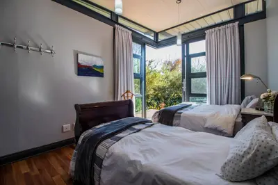 a bedroom with two beds and a window at Wolf Unit in Pretoria