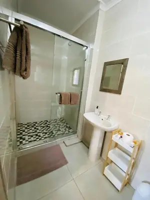 a bathroom with a shower and a sink at Shingalana Guest Lodge in Hazyview