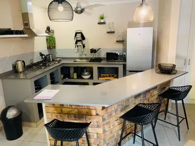 a kitchen with a large island in the middle at Shingalana Guest Lodge in Hazyview