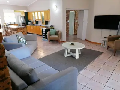 a living room with a couch and a table at Shingalana Guest Lodge in Hazyview