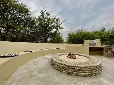 a patio with a stone fountain in the middle at Nghala Self-catering Holiday Home in Marloth Park