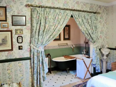 a bathroom with a bath tub and a sink at A Pilgrims Rest Guest House in Graskop in Graskop