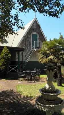 a house with a fountain in front of a building at A Pilgrims Rest Guest House in Graskop in Graskop