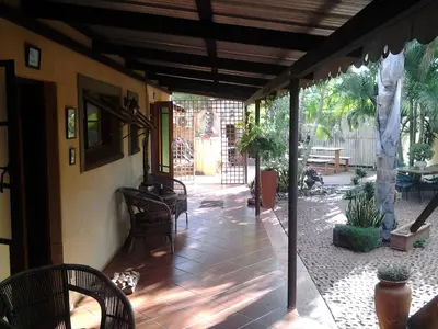 an outside patio with chairs and a table and a table at Africas Eden Guesthouse in Naboomspruit