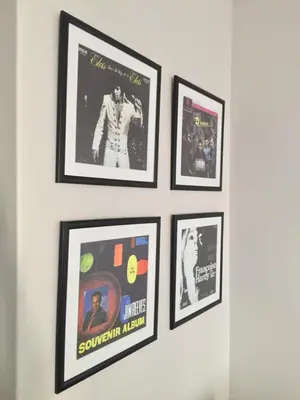 a group of framed pictures on a wall at HP Twelve Accommodation in Nelspruit