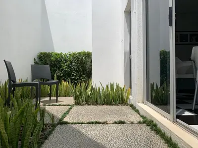 a patio with a chair and plants next to a building at HP Twelve Accommodation in Nelspruit